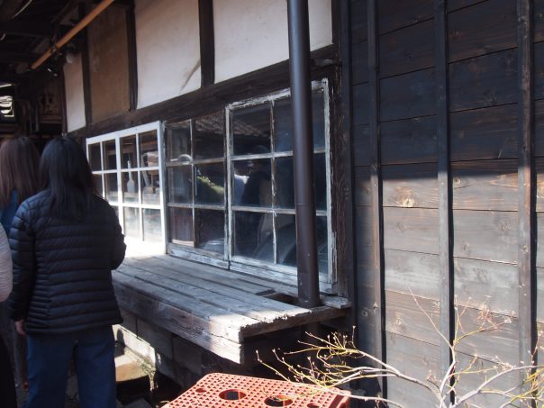 Wait in line to go inside sake brewery